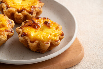 Delicious puff pastry Portuguese egg tart Pastel de nata in flower shape.