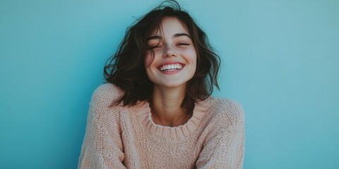 Fototapeta premium woman smiling in pastel-colored sweater blue background soft lighting cheerful and natural mood
