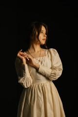 Fototapeta premium A very beautiful young lady, dressed in Victorian style.