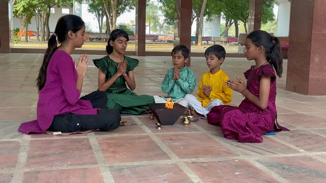 A Hindu family gathered around a sacred fire, performing a Yagya or havan