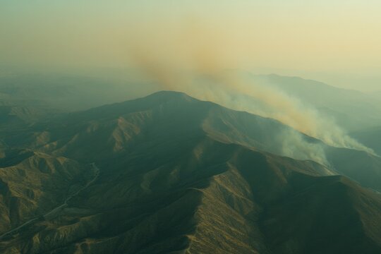 Wildfire action spreading across mountain range aerial view nature environment evocative imagery of destruction - Powered by Adobe