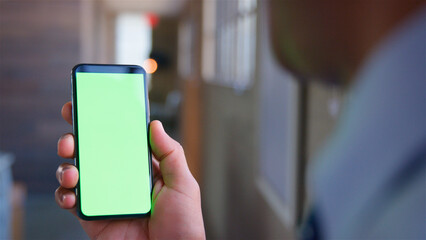 Over The Shoulder Close Up Shot Of Businessman Using Green Screen Mobile Phone