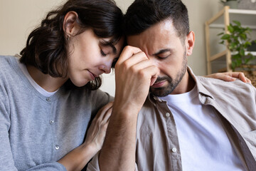 Close up of woman comforting husband.