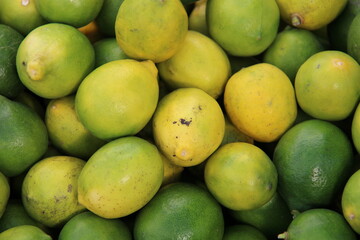 green lemons background on the market