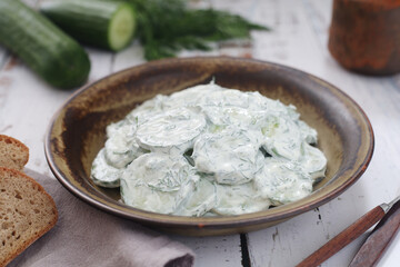 A traditional Polish salad Mizeria in rustic style