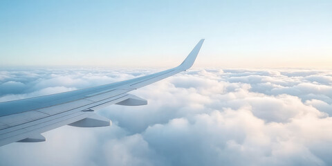 Fototapeta premium Airplane flying above fluffy sunny clouds, view from plane window of plane wing and sky