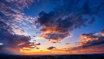 Obraz premium Dramatic sky background with vibrant colors of sunrise or sunset, perfect for landscape photography, travel content, or inspirational visuals