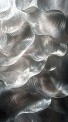 Naklejka premium Abstract design featuring flowing silver waves on a dark background
