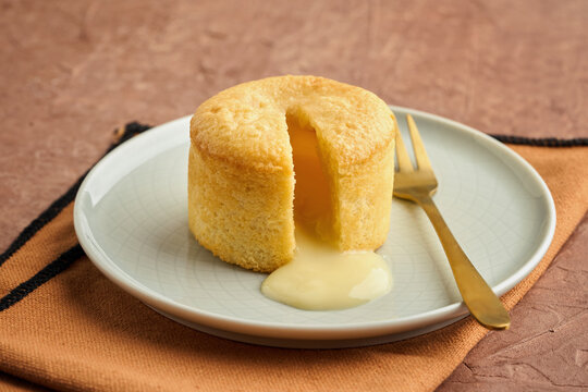 Vanilla Lava Cake with Warm Melted Center on Textured Background.