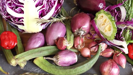 Mixed vegetables featuring purple cabbage, green okra, red shallots showcase eco-friendly harvest. Organic produce with vibrant colors represents eco approach to organic lifestyle.