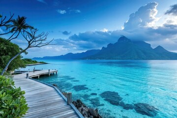 Fototapeta premium Serene Coastal Pathway Leading to a Tranquil Ocean View with Lush Greenery and Dramatic Mountains
