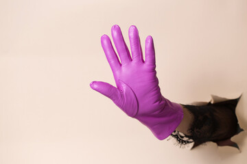 A woman's hand in a leather fuchsia glove waving his hand