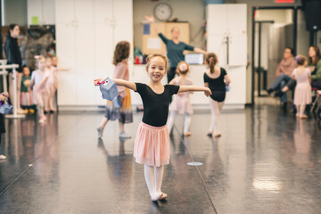 Cute little ballerina having fun on ballet room