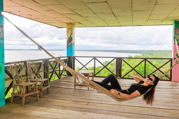 Relaxed woman resting in a hammock in the jungle