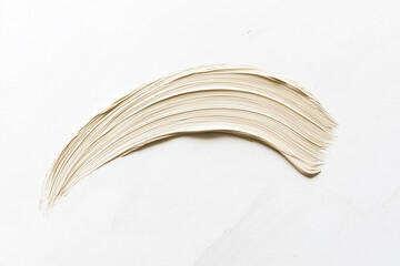 A long, curved brushstroke of light beige color on a white background. The stroke is made with acrylic paint and has an elegant shape