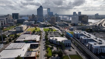Fototapeta premium Jacksonville, Florida city skyline beside St. Johns river downtown office buildings and streets working and living in coastal town in morning light as storm front passes over
