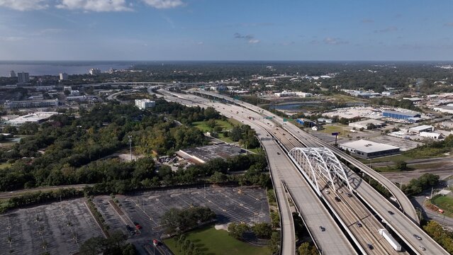 Traveling and driving on Interstate Highway I-95 through Jacksonville, Florida Aerial drone view of cars and trucks on roadway with multiple lanes across Landscape