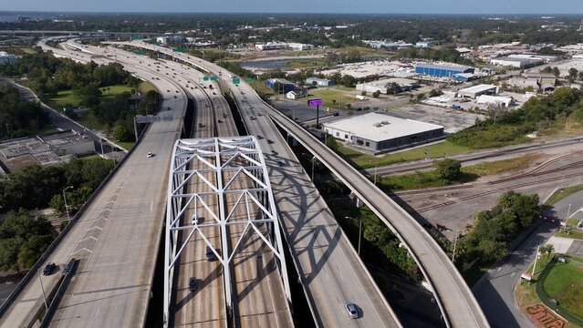 Traveling and driving on Interstate Highway I-95 through Jacksonville, Florida Aerial drone view of cars and trucks on roadway with multiple lanes across Landscape