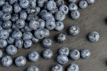 a pile of blueberries scattered on the board