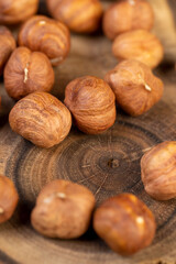 peeled raw hazelnuts on a table and a board