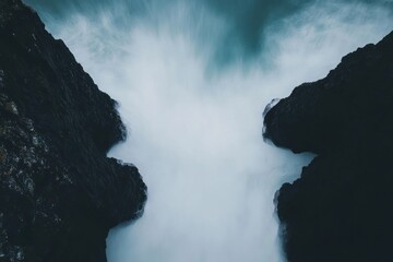 Dramatic Ocean Spray Between Dark Cliffs