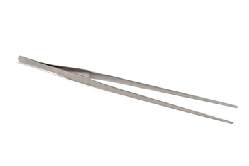 Large metal tweezers on a white background, medical equipment.