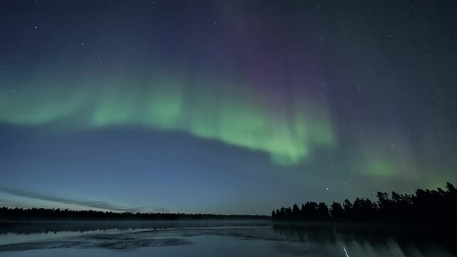 Zoom out from green and purple auroras, revealing a still lake