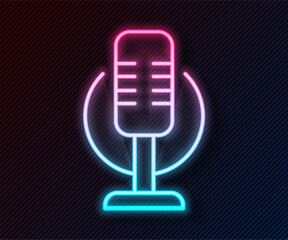 Glowing neon line Microphone icon isolated on black background. On air radio mic microphone. Speaker sign. Vector