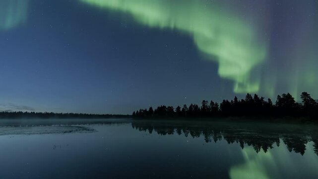 Aurora swirling above a foggy lake