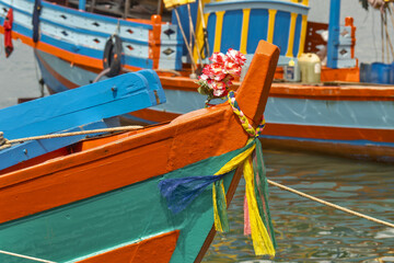 crab fishing boat in Ket, Cambodia

flower necklaces offered at the bow of a crab fishing boat in Ket, Cambodia. These offerings symbolize respect for the protective spirits of the sea