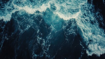Aerial view of the ocean waves captured by a drone photographer, highlighting the dynamic motion of ocean waves. Ideal for compositions with ample photo style copy space.