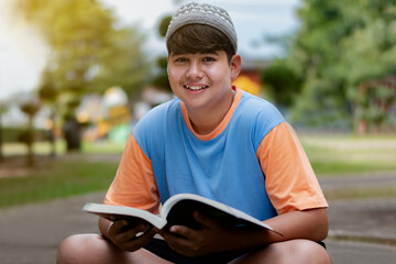 Daily lifestyle of nowadays asian muslim or islamic boy sitting in backyard of his house and...