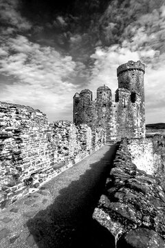 One of the broken towers of Conwy castle in black and white. Conwy Castle is one of the many Medieval Castles built by Edward I, in the 13th century as part of his conquest of Wales.