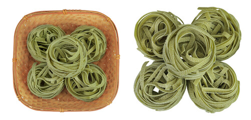 Raw tagliatelle green pasta with spinach in a wicker basket isolated on white background. Top view. Flat lay