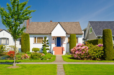 Two story stucco luxury house with nice summer  landscape in Vancouver, Canada, North America. Day...
