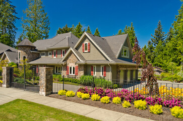 Two story stucco luxury house with nice summer  landscape in Vancouver, Canada, North America. Day...