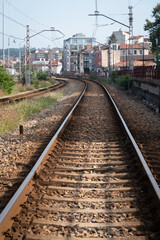 Obraz premium Train tracks with the city in the background in Avilés, Asturias, Spain