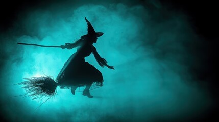 Silhouette of a witch flying on a broomstick in a mystical, teal-toned smoky background.