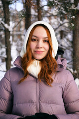 Porter of a young red-haired girl in the winter forest