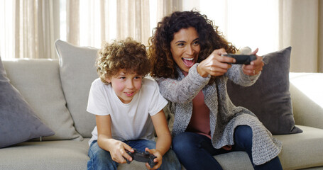 Video, game and mom on couch with son, smile and competition for bonding together in home. Excited,...