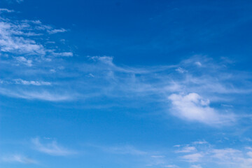 blue sky background with blurred light white clouds