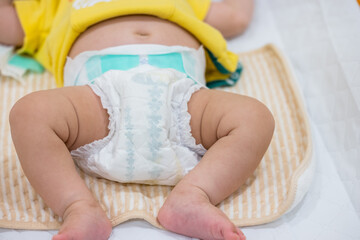 Adorable baby showing wet diaper indicator