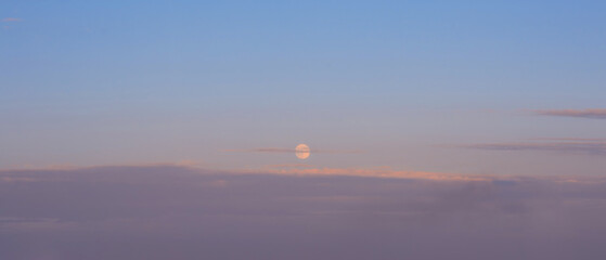 Moon and clouds in evening sky