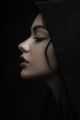 A captivating side-profile portrait of a woman in darkness.