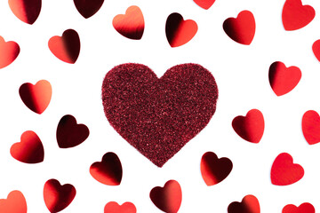 Red sparkle glitter heart and confetti on white background. Minimalist holiday