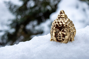 Golden Buddha Statue in Snowy Winter Landscape, Spiritual Winter