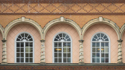 Three windows under arch of building in Country Club Plaza area of Kansas City, Missouri
