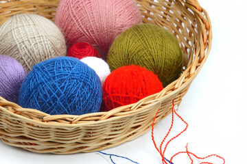 Obraz premium White with threads on the background. Threads basket white background balls of colored lies in a. A basket of balls of colored threads lies in a basket. A basket filled with various colored lifestyle.