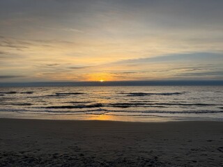Sunrise peaking over the waves
