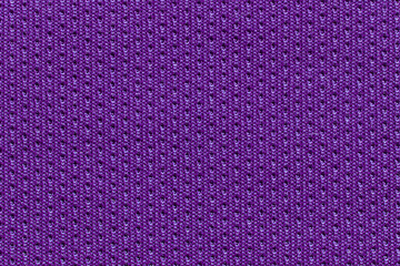 Detailed close up of vibrant purple textile fabric with texture and patterns.